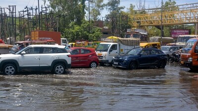 Vehicles ply on the waterlogged GT road after rain, in Ghaziabad. (PTI) Vehicles ply on the waterlogged GT road after rain, in Ghaziabad. (PTI)