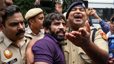 Police detain wrestler Bajrang Punia during wrestlers' protest against Wrestling Federation of India chief Brij Bhushan Sharan Singh in New Delhi on Sunday, (PTI) Police detain wrestler Bajrang Punia during wrestlers' protest against Wrestling Federation of India chief Brij Bhushan Sharan Singh in New Delhi on Sunday, (PTI)