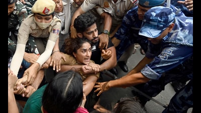 Security personnel detaining wrestler Vinesh Phogat during wrestlers' protest march towards new Parliament building, in New Delhi on Sunday. The wrestlers have been protesting agaisnt Wrestling Federation of India (WFI) chief Brij Bhushan Sharan Singh who they accused of sexually harassing women wrestlers. (HT FILE) Security personnel detaining wrestler Vinesh Phogat during wrestlers' protest march towards new Parliament building, in New Delhi on Sunday. The wrestlers have been protesting agaisnt Wrestling Federation of India (WFI) chief Brij Bhushan Sharan Singh who they accused of sexually harassing women wrestlers. (HT FILE)