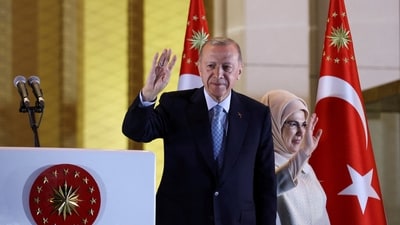 Turkish President Tayyip Erdogan and his wife Ermine Erdogan wave as he addresses his supporters following his victory. (REUTERS)