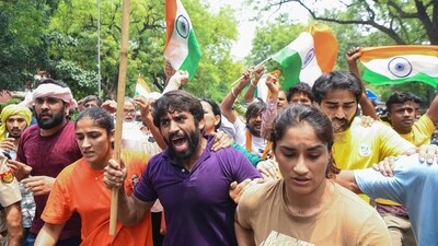 Wrestlers Bajrang Punia, Vinesh Phogat and Sangeeta Phogat along with supporters protesting against the alleged sexual harassment of women wrestlers by WFI chief Brij Bhushan Sharan Singh. (ANI) Wrestlers Bajrang Punia, Vinesh Phogat and Sangeeta Phogat along with supporters protesting against the alleged sexual harassment of women wrestlers by WFI chief Brij Bhushan Sharan Singh. (ANI)