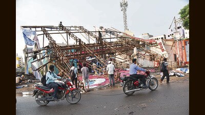 Four bikes were damaged after the hoarding at Lakshmi Chowk Marunji Road collapsed due to rain and strong winds on Tuesday. (HT PHOTO)