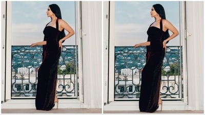 Sunny Leone's captivating dark maroon gown, crafted from luxurious velvet fabric, features a halter neck design, a flattering bodycon fit, a stylish side slit, and an attached cape that drapes gracefully with sleeves on one side. (Instagram/@sunnyleone) Sunny Leone's captivating dark maroon gown, crafted from luxurious velvet fabric, features a halter neck design, a flattering bodycon fit, a stylish side slit, and an attached cape that drapes gracefully with sleeves on one side. (Instagram/@sunnyleone)