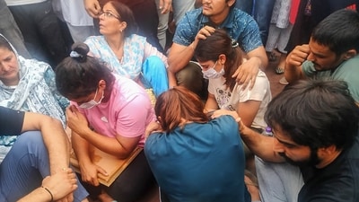 Protesting wrestlers sit at Har ki Pauri, in Haridwar district, Tuesday, May 30, 2023. (PTI) Protesting wrestlers sit at Har ki Pauri, in Haridwar district, Tuesday, May 30, 2023. (PTI)