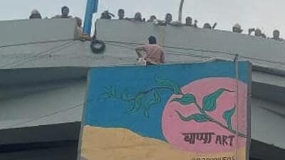 A young person on Tuesday staged a protest by climbing the bridge in front of Sancheti Hospital in Shivajinagar, reminiscent of the blockbuster film ‘Sholay’. resulting in traffic congestion. (HT)