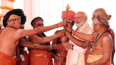 Prime Minister Narendra Modi holds a sengol with Hindu priests during the inauguration of new Parliament building in New Delhi. (Reuters)