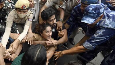 Security personnel detain wrestlers Vinesh Phogat during wrestlers' protest march towards new Parliament building, in New Delhi, India, on Sunday. (HT FILE) Security personnel detain wrestlers Vinesh Phogat during wrestlers' protest march towards new Parliament building, in New Delhi, India, on Sunday. (HT FILE)