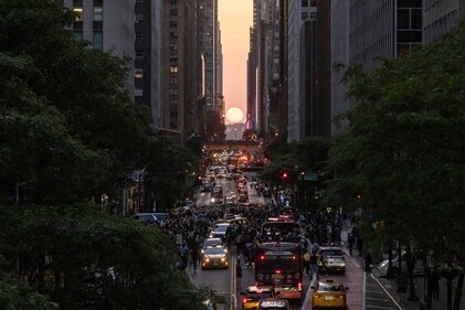 The sun sets as seen through the middle of buildings along 42nd Street in New York during a phenomenon known as Manhattanhenge, Tuesday, May 30, 2023. (AP)
