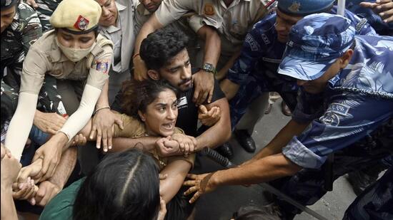 Security personnel detain wrestlers Vinesh Phogat during wrestlers' protest march towards new Parliament building, in New Delhi, India, on Sunday. (HT FILE)