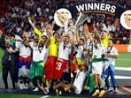 Sevilla celebrate with the trophy after winning the Europa League