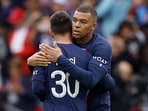 Kylian Mbappe celebrates scoring their first goal with Lionel Messi