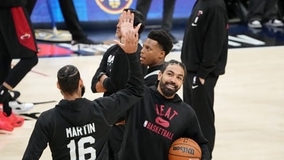 May 31, 2023; Denver, CO, USA; Miami Heat guard Gabe Vincent (right) and forward Caleb Martin (16) high five during a practice session on media day before the 2023 NBA Finals at Ball Arena. Mandatory Credit: Kyle Terada-USA TODAY Sports (USA TODAY Sports via Reuters Con)