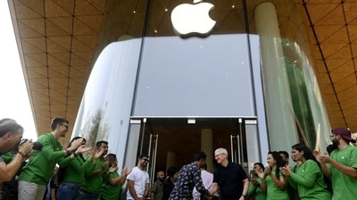 Tim Cook, chief executive officer of Apple, Inc., center right, shakes hands with a customer during the opening of the new Apple BKC store in Mumbai. (Bloomberg)
