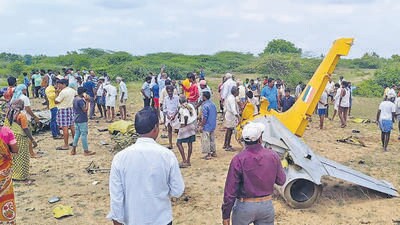 Local residents at the site where a Kiran trainer aircraft crashed, in Karnataka’s Chamarajanagar district, on Thursday. (PTI) Local residents at the site where a Kiran trainer aircraft crashed, in Karnataka’s Chamarajanagar district, on Thursday. (PTI)