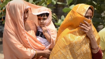 Women cover themselves with their clothes because of heatwave conditions. (PTI)