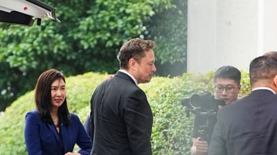 Tesla Chief Executive Officer Elon Musk walks at Shanghai Hongqiao International Airport in Shanghai. (Reuters)