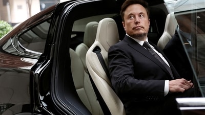 Tesla CEO Elon Musk gets in a Tesla car as he leaves a hotel in Beijing. (Reuters)