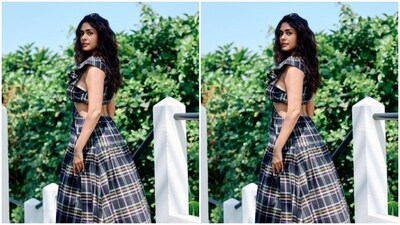 Mrunal looked every bit stunning in the blue checkered long summer dress featuring a plunging neckline, frill patterns at the shoulders, and sleeveless details.&nbsp; (Instagram/@mrunalthakur)