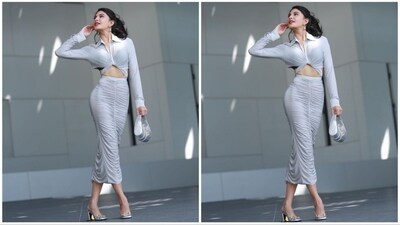 Her stunning outfit is sourced from the fashion brand Alex Perry. It consists of an off-white shirt with a V-neck, twisted knot detailing, and full sleeves. She paired it with a matching pleated bodycon skirt. (Instagram/@jacquelinef143) Her stunning outfit is sourced from the fashion brand Alex Perry. It consists of an off-white shirt with a V-neck, twisted knot detailing, and full sleeves. She paired it with a matching pleated bodycon skirt. (Instagram/@jacquelinef143)