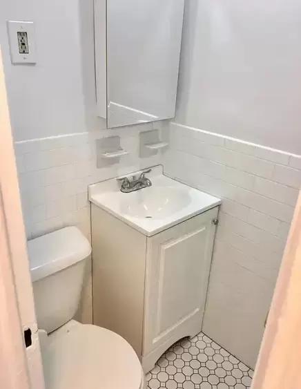 The shared bathroom is in the hallway and is used by four other tenants. (Compass)