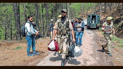 A police personnel carrying arms, ammunition and other materials recovered from the terrorist killed in Dassal Rajouri on Friday. (ANI) A police personnel carrying arms, ammunition and other materials recovered from the terrorist killed in Dassal Rajouri on Friday. (ANI)