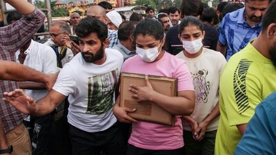 Olympic medalist wrestlers Sangeeta Phogat, Sakshi Malik and others, who have accused the Wrestling Federation of India (WFI) chief Brij Bhushan Sharan Singh of sexual harassment and are demanding his arrest. (ANI) Olympic medalist wrestlers Sangeeta Phogat, Sakshi Malik and others, who have accused the Wrestling Federation of India (WFI) chief Brij Bhushan Sharan Singh of sexual harassment and are demanding his arrest. (ANI)