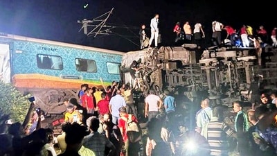 Locals gather after the Coromandel Express derails after hitting a goods train near Bahanaga station in Balasore on Friday. (ANI Photo) Locals gather after the Coromandel Express derails after hitting a goods train near Bahanaga station in Balasore on Friday. (ANI Photo)