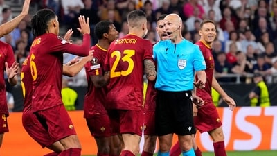 Roma players talk to Referee Anthony Taylor before he checks the VAR for a possible penalty during the Europa League final soccer match between Sevilla and Roma, at the Puskas Arena in Budapest. (AP) Roma players talk to Referee Anthony Taylor before he checks the VAR for a possible penalty during the Europa League final soccer match between Sevilla and Roma, at the Puskas Arena in Budapest. (AP)