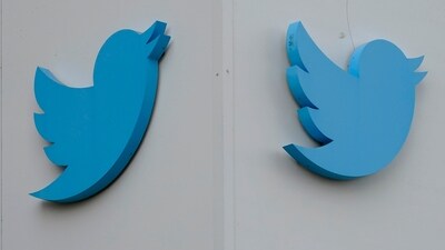 Twitter logos hang outside the company's offices in San Francisco, (AP)