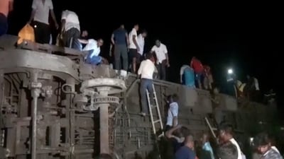 In this photo, people can be seen escaping from toppled compartments, following the deadly collision of multiple trains, in Balasore, Odisha.&nbsp; (REUTERS)