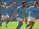 Manchester City's German midfielder Ilkay Gundogan (C) celebrates after scoring the early opening goal during the English FA Cup final 