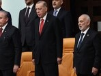 Turkish President Recep Tayyip Erdogan (C), former Speaker of the Turkish Grand National Assembly Mustafa Sentop (L) and new elected Yeniden Refah party's MP Suat Pamukcu (R)stand during the 28th term deputies' oath-taking ceremony at the Turkish Grand National Assembly in Ankara, on June 02, 2023. 