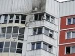 Russia-Ukraine War: A woman looks out of a window of a damaged multi-storey apartment block following a reported drone attack in Moscow.