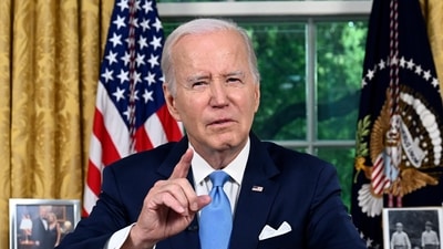 President Joe Biden addresses the nation on the budget deal that lifts the federal debt limit and averts a U.S. government default, from the Oval Office of the White House in Washington, Friday. (AP) President Joe Biden addresses the nation on the budget deal that lifts the federal debt limit and averts a U.S. government default, from the Oval Office of the White House in Washington, Friday. (AP)