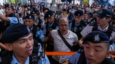 Police officers take away a member of the public in the Causeway Bay area on the eve of the 34th anniversary of China's Tiananmen Square massacre, in Hong Kong, Saturday. (AP) Police officers take away a member of the public in the Causeway Bay area on the eve of the 34th anniversary of China's Tiananmen Square massacre, in Hong Kong, Saturday. (AP)