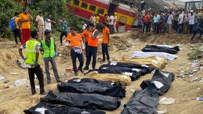 Medical workers stand in front of the bodies of victims killed in an accident after a three-train collision near Balasore. (AFP) Medical workers stand in front of the bodies of victims killed in an accident after a three-train collision near Balasore. (AFP)
