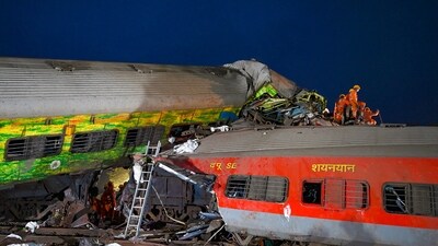 Rescue workers recover victims' bodies from the carriage wreckage of a three-train collision near Balasore, in India's eastern state of Odisha. (AFP)