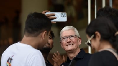 Apple BKC store launch: Tim Cook, chief executive officer of Apple, Inc., center, poses for selfies with a customer during the opening of the new Apple BKC store in Mumbai. (Bloomberg) Apple BKC store launch: Tim Cook, chief executive officer of Apple, Inc., center, poses for selfies with a customer during the opening of the new Apple BKC store in Mumbai. (Bloomberg)