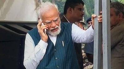 Prime Minister Narendra Modi talks on mobile phone as he visits the train accident site in Balasore district, Saturday, June 3, 2023. (PTI) Prime Minister Narendra Modi talks on mobile phone as he visits the train accident site in Balasore district, Saturday, June 3, 2023. (PTI)