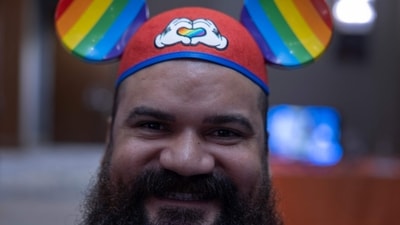 ORLANDO, FLORIDA - JUNE 02: Tony Vega wears a Mickey Mouse hat as he attends the Gay Days at the DoubleTree by Hilton Orlando at SeaWorld on June 02, 2023 in Orlando, Florida. As Florida Gov. Ron DeSantis and Florida lawmakers passed anti-LGBTQ laws, Gay Days organizers encouraged visitors to continue to attend one of Florida�s largest gay and lesbian celebrations. One part of the festivities for the weekend will be a Saturday meetup of LGBTQ visitors at the Magic Kingdom at Walt Disney World, even as Disney is in a legal fight with DeSantis over the governor and Florida Republican lawmakers taking over Disney World�s governing district after Disney officials publicly opposed legislation that critics have dubbed �Don�t Say, Gay.� Joe Raedle/Getty Images/AFP (Photo by JOE RAEDLE / GETTY IMAGES NORTH AMERICA / Getty Images via AFP) (Getty Images via AFP) ORLANDO, FLORIDA - JUNE 02: Tony Vega wears a Mickey Mouse hat as he attends the Gay Days at the DoubleTree by Hilton Orlando at SeaWorld on June 02, 2023 in Orlando, Florida. As Florida Gov. Ron DeSantis and Florida lawmakers passed anti-LGBTQ laws, Gay Days organizers encouraged visitors to continue to attend one of Florida�s largest gay and lesbian celebrations. One part of the festivities for the weekend will be a Saturday meetup of LGBTQ visitors at the Magic Kingdom at Walt Disney World, even as Disney is in a legal fight with DeSantis over the governor and Florida Republican lawmakers taking over Disney World�s governing district after Disney officials publicly opposed legislation that critics have dubbed �Don�t Say, Gay.� Joe Raedle/Getty Images/AFP (Photo by JOE RAEDLE / GETTY IMAGES NORTH AMERICA / Getty Images via AFP) (Getty Images via AFP)