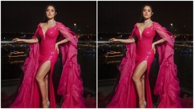 Nushrratt decked up in the pink sequined gown with a plunging neckline, sleeveless details and a thigh high slit. The gown also came with dramatic tulle floor-sweeping trains starting from the shoulders.&nbsp; (Instagram/@tanieyakhanuja)