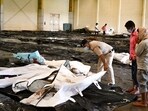 A policeman helps a man to identify his family member's body at a business park used as temporary mortuary for the dead recovered from the carriage wreckage of the three-train collision. A policeman helps a man to identify his family member's body at a business park used as temporary mortuary for the dead recovered from the carriage wreckage of the three-train collision.