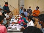 Officials display pictures of victims for family members to identify bodies at a business park used as temporary mortuary for the dead recovered from the carriage wreckage of a three-train collision near Balasore, Odisha, on Sunday. Officials display pictures of victims for family members to identify bodies at a business park used as temporary mortuary for the dead recovered from the carriage wreckage of a three-train collision near Balasore, Odisha, on Sunday.