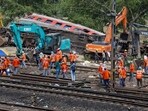 Heavy machinery remove damaged coaches from the railway tracks at the site of a train collision following the accident in Balasore district in the eastern state of Odisha on Sunday. 