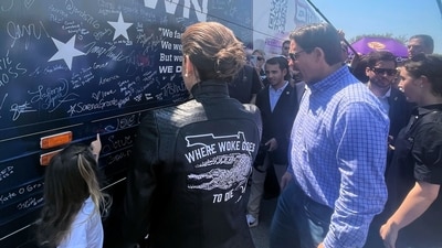 Casey DeSantis, center, the wife of presidential candidate Ron DeSantis, stands in front of the bus for her husband's super PAC, Never Back Down, at U.S. Sen. Joni Ernest's Roast and Ride, Saturday, June 3, 2023, in Des Moines, Iowa. (AP Photo/Hannah Fingerhut) (AP) Casey DeSantis, center, the wife of presidential candidate Ron DeSantis, stands in front of the bus for her husband's super PAC, Never Back Down, at U.S. Sen. Joni Ernest's Roast and Ride, Saturday, June 3, 2023, in Des Moines, Iowa. (AP Photo/Hannah Fingerhut) (AP)