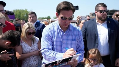 Republican presidential candidate Florida Gov. Ron DeSantis signs an autograph for a supporter. (AP) Republican presidential candidate Florida Gov. Ron DeSantis signs an autograph for a supporter. (AP)