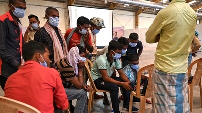 Victims' family members look at photographs to identify bodies at a business park used as temporary mortuary for the dead recovered from the carriage wreckage of a three-train collision near Balasore of Odisha, on Sunday. (AFP) Victims' family members look at photographs to identify bodies at a business park used as temporary mortuary for the dead recovered from the carriage wreckage of a three-train collision near Balasore of Odisha, on Sunday. (AFP)