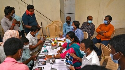 Officials display pictures of victims for family members to identify bodies at a business park used as temporary mortuary for the dead recovered from the carriage wreckage of a three-train collision near Balasore, Odisha, on Sunday. (AFP) Officials display pictures of victims for family members to identify bodies at a business park used as temporary mortuary for the dead recovered from the carriage wreckage of a three-train collision near Balasore, Odisha, on Sunday. (AFP)