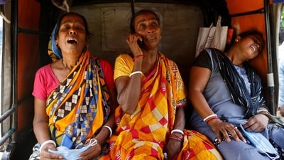 Relatives of victims react as they sit in an autorickshaw outside a temporary mortuary created in a business park following the train collision in Balasore district in Odisha. (REUTERS)
