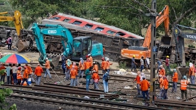 Heavy machinery remove damaged coaches from the railway tracks at the site of a train collision following the accident in Balasore district in the eastern state of Odisha, India, June 4, 2023. (REUTERS)